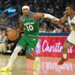 Dec 25, 2025; San Francisco, California, USA; Dallas Mavericks guard Brandon Williams (10) dribbles against Golden State Warriors guard De'Anthony Melton (8) during the second quarter at Chase Center. Mandatory Credit: Darren Yamashita-Imagn Images