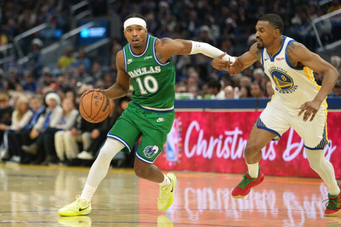 Dec 25, 2025; San Francisco, California, USA; Dallas Mavericks guard Brandon Williams (10) dribbles against Golden State Warriors guard De'Anthony Melton (8) during the second quarter at Chase Center. Mandatory Credit: Darren Yamashita-Imagn Images