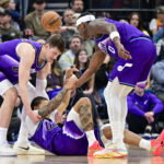 Jan 10, 2026; Salt Lake City, Utah, USA; Utah Jazz guard Keyonte George (3) is helped up after being fouled during the first half against the Charlotte Hornets at Delta Center. Mandatory Credit: Peter Creveling-Imagn Images
