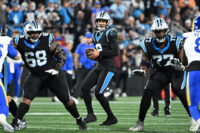 Jan 10, 2026; Charlotte, NC, USA; Carolina Panthers quarterback Bryce Young (9) looks to pass as guard Damien Lewis (68) and offensive tackle Yosh Nijman (77) block in the third quarter in an NFC Wild Card Round game at Bank of America Stadium. Mandatory Credit: Bob Donnan-Imagn Images