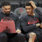 Feb 25, 2026; Houston, Texas, USA; Houston Rockets forward Jabari Smith Jr. (right) looks at a computer with assistant coach Garrett Jackson before the game against the Sacramento Kings at Toyota Center. Mandatory Credit: Troy Taormina-Imagn Images