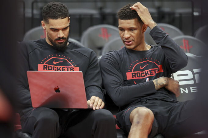 Feb 25, 2026; Houston, Texas, USA; Houston Rockets forward Jabari Smith Jr. (right) looks at a computer with assistant coach Garrett Jackson before the game against the Sacramento Kings at Toyota Center. Mandatory Credit: Troy Taormina-Imagn Images