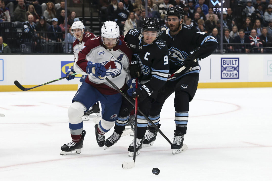Feb 25, 2026; Salt Lake City, Utah, USA; Colorado Avalanche defenseman Devon Toews (7) and Utah Mammoth right wing Clayton Keller (9) battle for the puck during the first period at Delta Center. Mandatory Credit: Rob Gray-Imagn Images