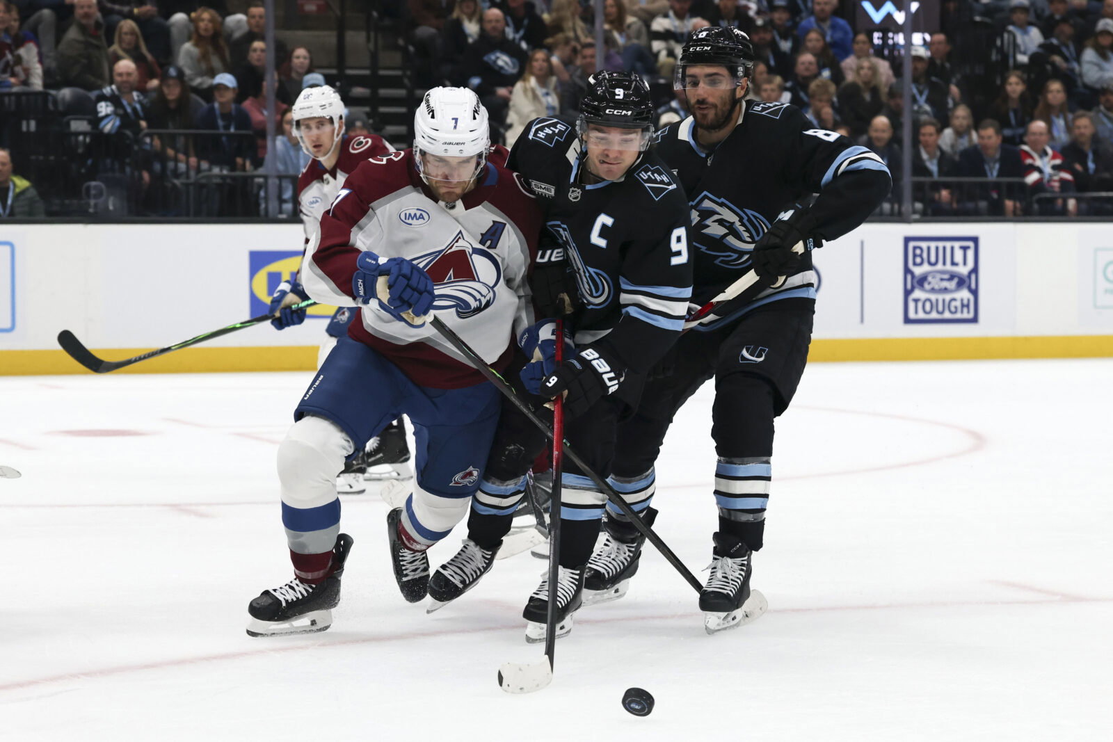 Feb 25, 2026; Salt Lake City, Utah, USA; Colorado Avalanche defenseman Devon Toews (7) and Utah Mammoth right wing Clayton Keller (9) battle for the puck during the first period at Delta Center. Mandatory Credit: Rob Gray-Imagn Images