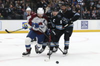 Feb 25, 2026; Salt Lake City, Utah, USA; Colorado Avalanche defenseman Devon Toews (7) and Utah Mammoth right wing Clayton Keller (9) battle for the puck during the first period at Delta Center. Mandatory Credit: Rob Gray-Imagn Images