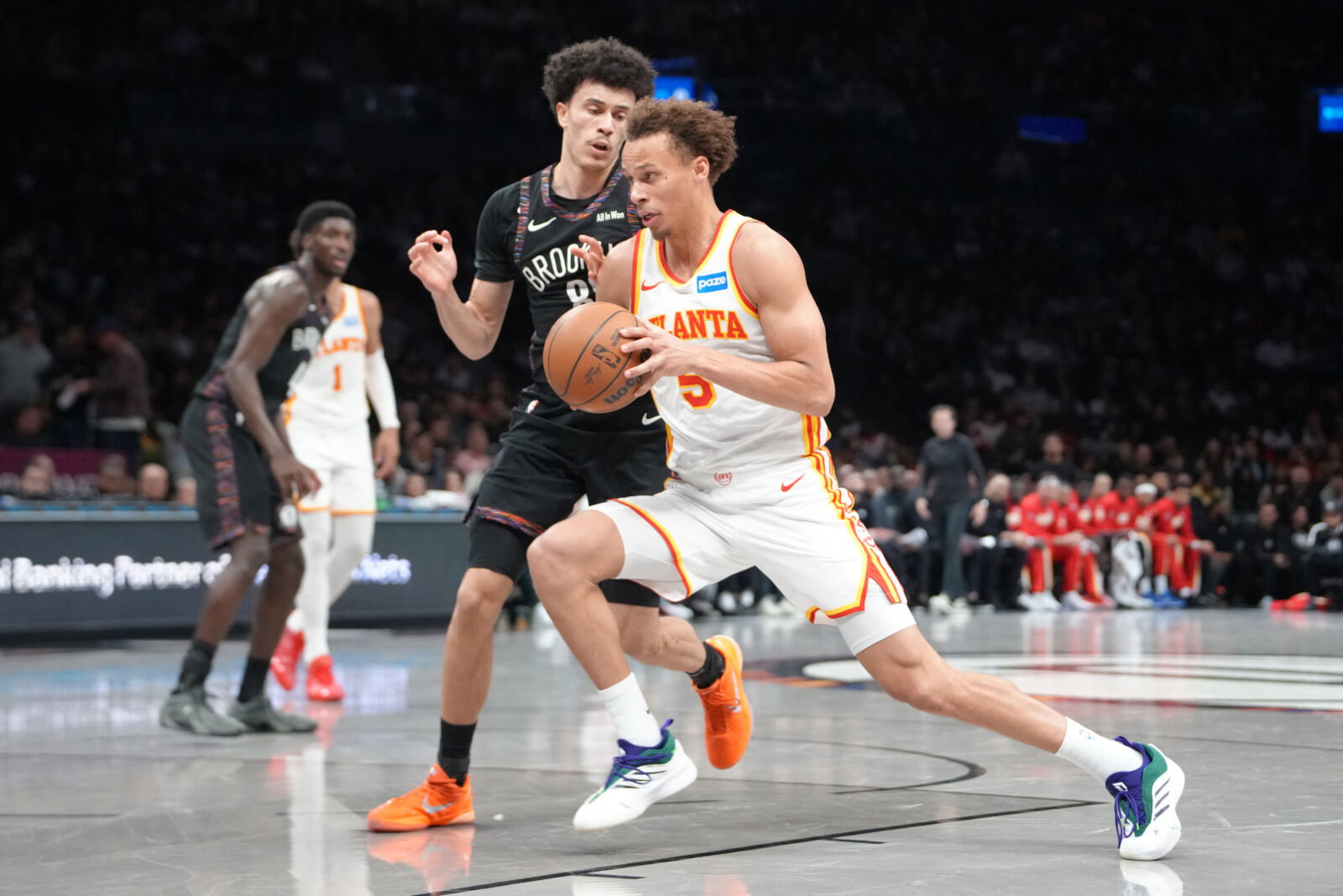 Apr 3, 2026; Brooklyn, New York, USA; Atlanta Hawks guard Dyson Daniels (5) drives the ball against Brooklyn Nets guard Nolan Traore (88) during the second half at Barclays Center. Mandatory Credit: Gregory Fisher-Imagn Images