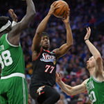 Apr 26, 2026; Philadelphia, Pennsylvania, USA; Philadelphia 76ers guard Vj Edgecombe (77) drives to the basket against Boston Celtics center Neemias Queta (88) and forward Sam Hauser (30) during the second half at Xfinity Mobile Arena. Mandatory Credit: Eric Hartline-Imagn Images