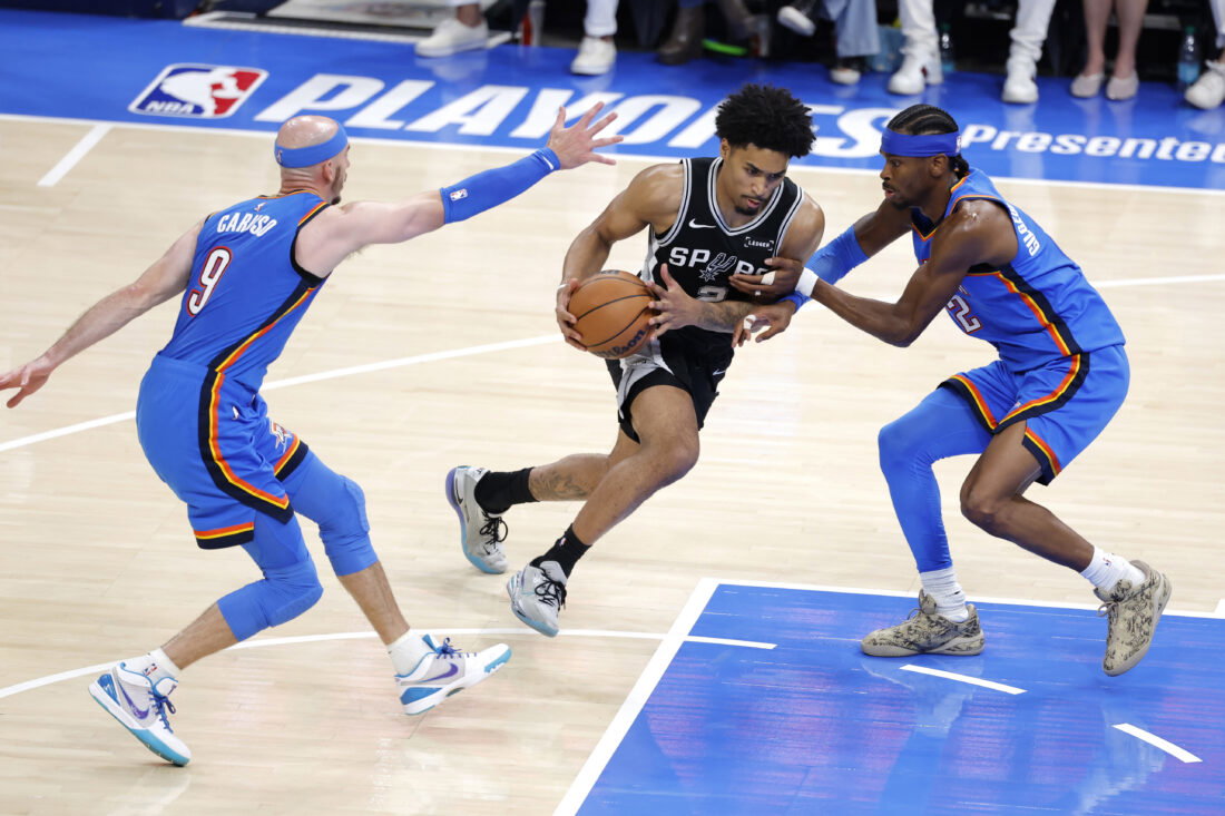 May 30, 2026; Oklahoma City, Oklahoma, USA; San Antonio Spurs guard Dylan Harper (2) controls the ball against Oklahoma City Thunder guard Shai Gilgeous-Alexander (2) and guard Alex Caruso (9) in the third quarter during game seven of the western conference finals for the 2026 NBA playoffs at Paycom Center. Mandatory Credit: Alonzo Adams-Imagn Images