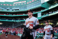 Jun 3, 2026; Boston, Massachusetts, USA; Baltimore Orioles catcher Adley Rutschman (35) and field coordinator/catching coach Joe Singley (87) walk to the bullpen before the start of the game against the Boston Red Sox at Fenway Park. Mandatory Credit: David Butler II-Imagn Images