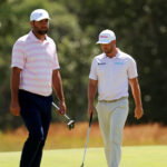 Jun 21, 2026; Southampton, New York, USA; Scottie Scheffler and Wyndham Clark setup their play on the second green during the final round of the U.S. Open golf tournament at Shinnecock Hills Golf Club. Mandatory Credit: Bill Streicher-Imagn Images