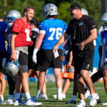Detroit Lions quarterback Jared Goff (16), left, talks to head coach Dan Campbell at practice during training camp at Meijer Performance Center in Allen Park on Wednesday, July 29, 2026.