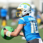 Jul 31, 2026; El Segundo, CA, USA; Los Angeles Chargers quarterback Justin Herbert (10) holds a KHAOS Water Ball during training camp at The Bolt. Mandatory Credit: Kirby Lee-Imagn Images