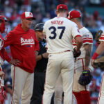 Aug 1, 2026; Anaheim, California, USA; Los Angeles Angels pitching coach Mike Maddux (second from left) talks with pitcher Brent Suter (37) during a mound visit in the second inning against the Milwaukee Brewers at Angel Stadium. Mandatory Credit: Kiyoshi Mio-Imagn Images