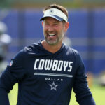 Aug 11, 2026; Woodland Hills, CA, USA; Dallas Cowboys head coach Brian Schottenheimer reacts during a joint practice against the Los Angeles Rams at the Rams Practice Facility. Mandatory Credit: Kirby Lee-Imagn Images