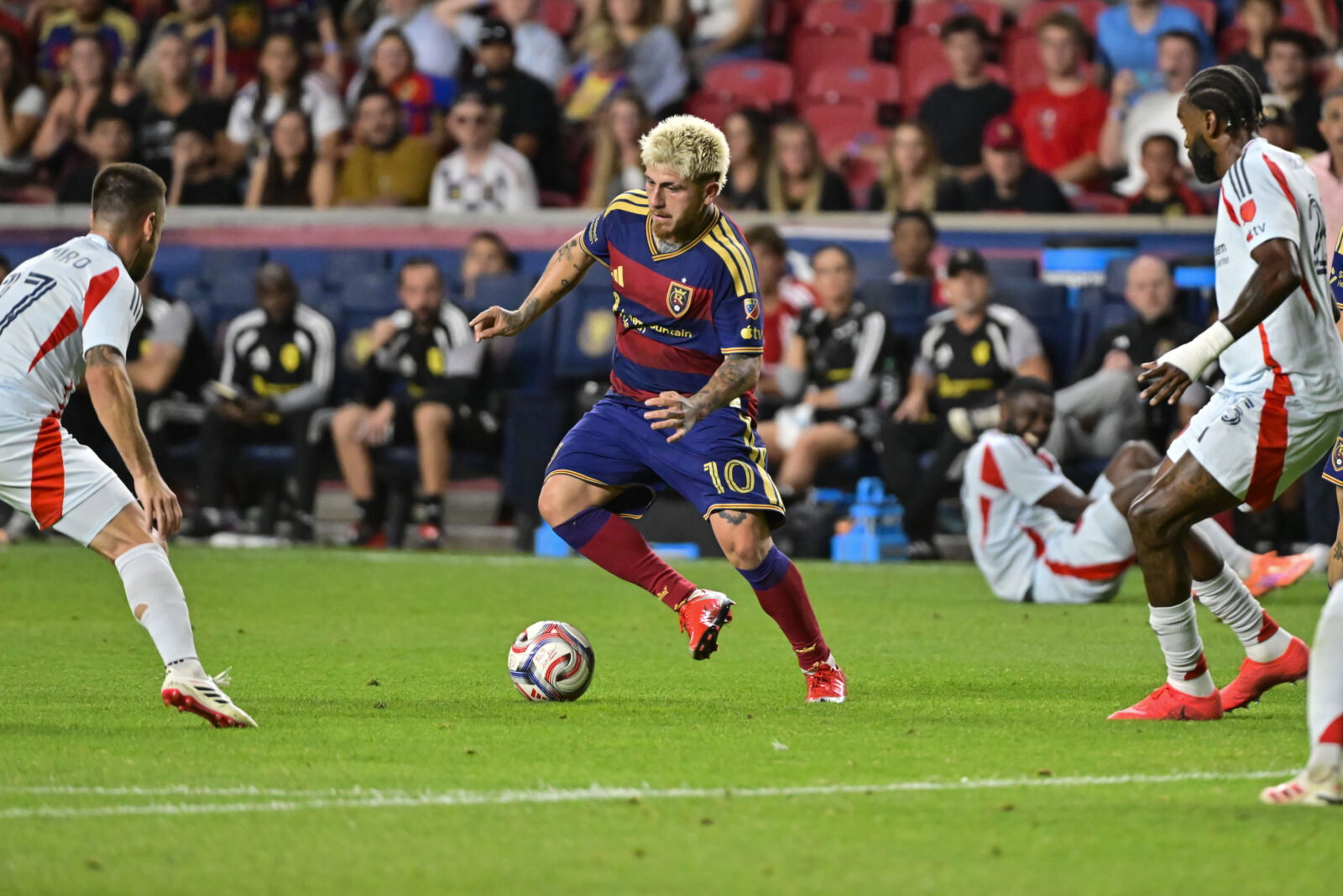 Aug 19, 2026; Sandy, Utah, USA; Real Salt Lake midfielder Diego Luna (10) navigates through the defense by FC Dallas midfielder Ramiro Benetti (17) and defender Sebastien Ibeagha (25) during the second half at America First Field. Mandatory Credit: Peter Creveling-Imagn Images