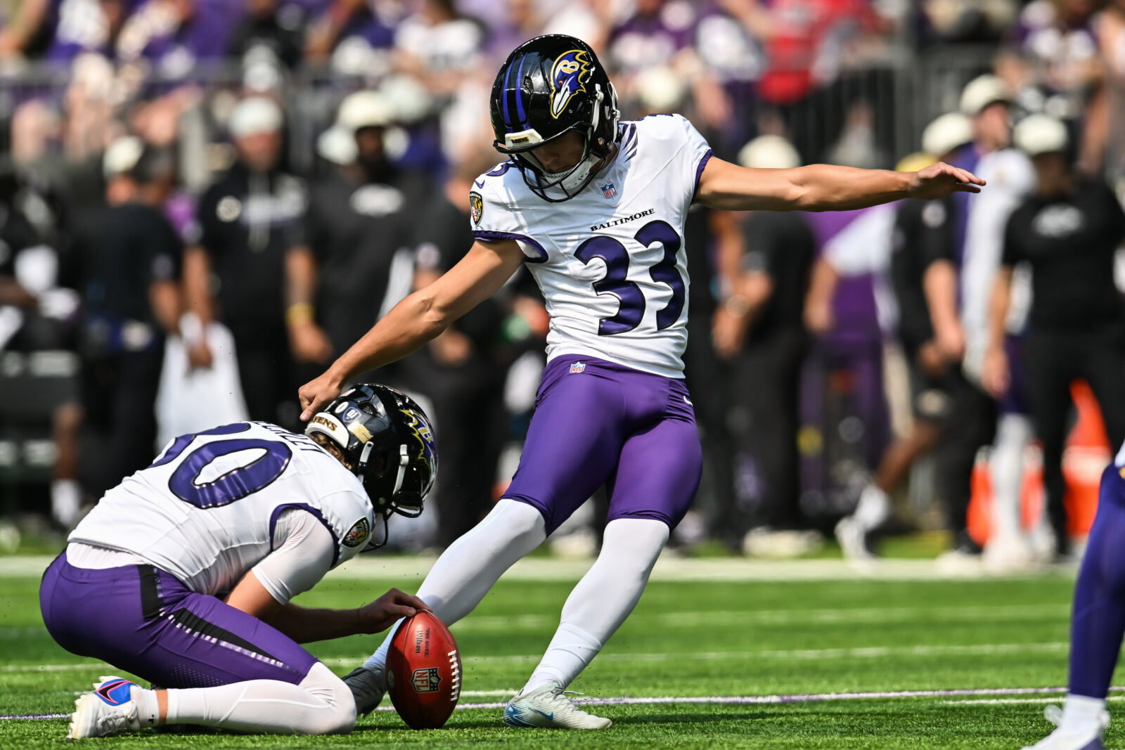 Aug 22, 2026; Minneapolis, Minnesota, USA; Baltimore Ravens place kicker Tyler Loop (33) kicks a field goal as punter Ryan Eckley (30) holds during the third quarter against the Minnesota Vikings at U.S. Bank Stadium. Mandatory Credit: Jeffrey Becker-Imagn Images