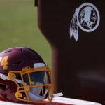 Aug 20, 2020; Ashburn, Virginia, USA; The helmet of Washington Football Team running back Antonio Gibson (not pictured) rests on a cooler next to a trashcan with the retired Washington Redskins logo on day twenty-three of training camp at Inova Sports Performance Center in Ashburn, Virginia. Mandatory Credit: Geoff Burke-USA TODAY Sports
