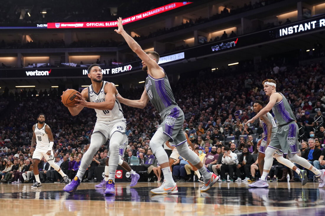 Nov 15, 2022; Sacramento, California, USA; Brooklyn Nets guard Ben Simmons (10) spins towards the hoop next to Sacramento Kings forward Domantas Sabonis (10) in the second quarter at the Golden 1 Center. Mandatory Credit: Cary Edmondson-USA TODAY Sports