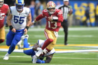 Sep 22, 2024; Inglewood, California, USA; San Francisco 49ers quarterback Brock Purdy (13) breaks away from Los Angeles Rams defensive tackle Kobie Turner (91) for a first down in the second half at SoFi Stadium. Mandatory Credit: Jayne Kamin-Oncea-Imagn Images