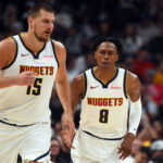 Oct 14, 2025; Denver, Colorado, USA; Denver Nuggets forward Peyton Watson (8) after scoring on an assist by center Nikola Jokic (15) during the first half at Ball Arena. Mandatory Credit: Christopher Hanewinckel-Imagn Images