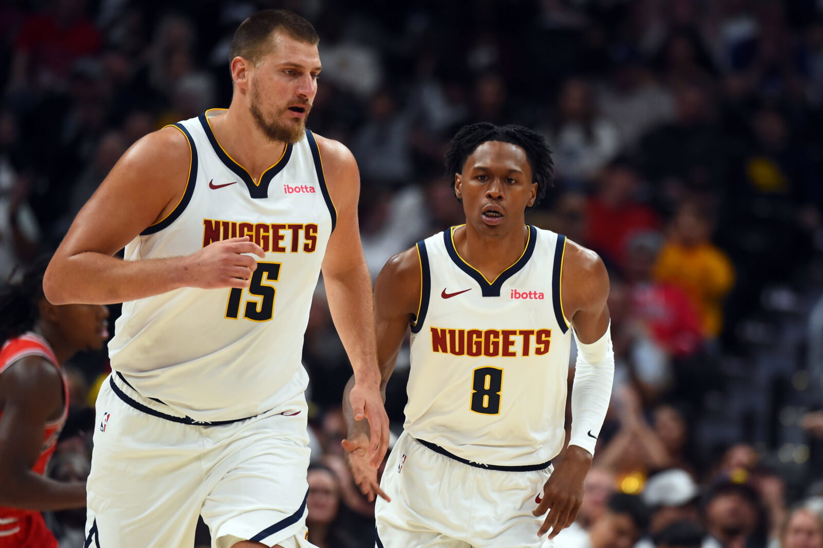 Oct 14, 2025; Denver, Colorado, USA; Denver Nuggets forward Peyton Watson (8) after scoring on an assist by center Nikola Jokic (15) during the first half at Ball Arena. Mandatory Credit: Christopher Hanewinckel-Imagn Images