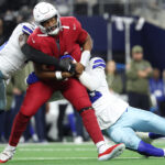 Nov 3, 2025; Arlington, Texas, USA; Dallas Cowboys defensive end Jadeveon Clowney (42) and defensive end Donovan Ezeiruaku (41) sack Arizona Cardinals quarterback Jacoby Brissett (7) in the first half at AT&T Stadium. Mandatory Credit: Kevin Jairaj-Imagn Images