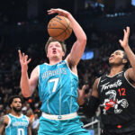 Nov 17, 2025; Toronto, Ontario, CAN; Charlotte Hornets forward Kon Kneuppel (7) blocks a pass intended for Toronto Raptors forward Collin Murray-Boyles (12) in the first half at Scotiabank Arena. Mandatory Credit: Dan Hamilton-Imagn Images