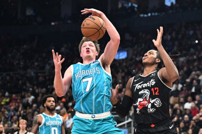 Nov 17, 2025; Toronto, Ontario, CAN; Charlotte Hornets forward Kon Kneuppel (7) blocks a pass intended for Toronto Raptors forward Collin Murray-Boyles (12) in the first half at Scotiabank Arena. Mandatory Credit: Dan Hamilton-Imagn Images