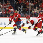 Dec 11, 2025; Washington, District of Columbia, USA; Washington Capitals left wing Alex Ovechkin (8) shoots the puck as Carolina Hurricanes defenseman Alexander Nikishin (21) defends during the third period at Capital One Arena. Mandatory Credit: Geoff Burke-Imagn Images