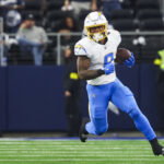 Dec 21, 2025; Arlington, Texas, USA; Los Angeles Chargers running back Omarion Hampton (8) rushes against the Dallas Cowboys during the second quarter at AT&T Stadium. Mandatory Credit: Kevin Jairaj-Imagn Images