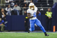 Dec 21, 2025; Arlington, Texas, USA; Los Angeles Chargers running back Omarion Hampton (8) rushes against the Dallas Cowboys during the second quarter at AT&T Stadium. Mandatory Credit: Kevin Jairaj-Imagn Images