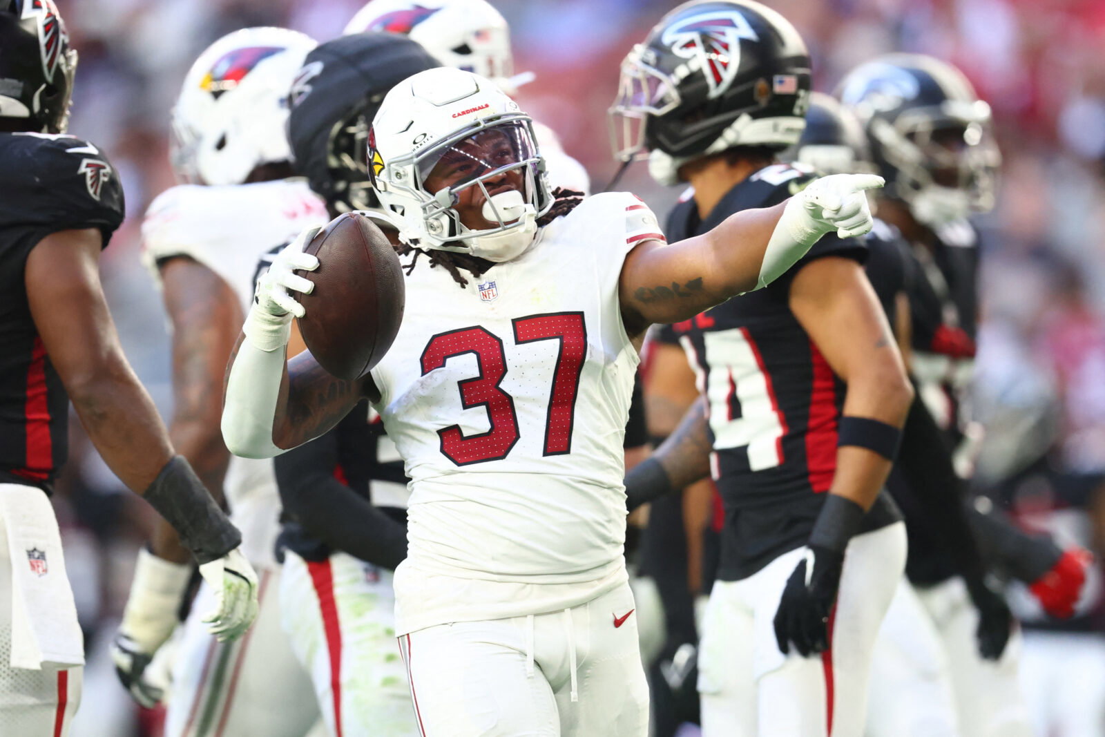 Dec 21, 2025; Glendale, Arizona, USA; Arizona Cardinals running back Corey Kiner (37) celebrates after a carry against the Atlanta Falcons during the first half at State Farm Stadium. Mandatory Credit: