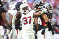 Dec 21, 2025; Glendale, Arizona, USA; Arizona Cardinals running back Corey Kiner (37) celebrates after a carry against the Atlanta Falcons during the first half at State Farm Stadium. Mandatory Credit: