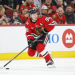 Mar 9, 2026; Chicago, Illinois, USA; Chicago Blackhawks center Connor Bedard (98) looks to pass the puck against the Utah Mammoth during the first period at United Center. Mandatory Credit: Kamil Krzaczynski-Imagn Images