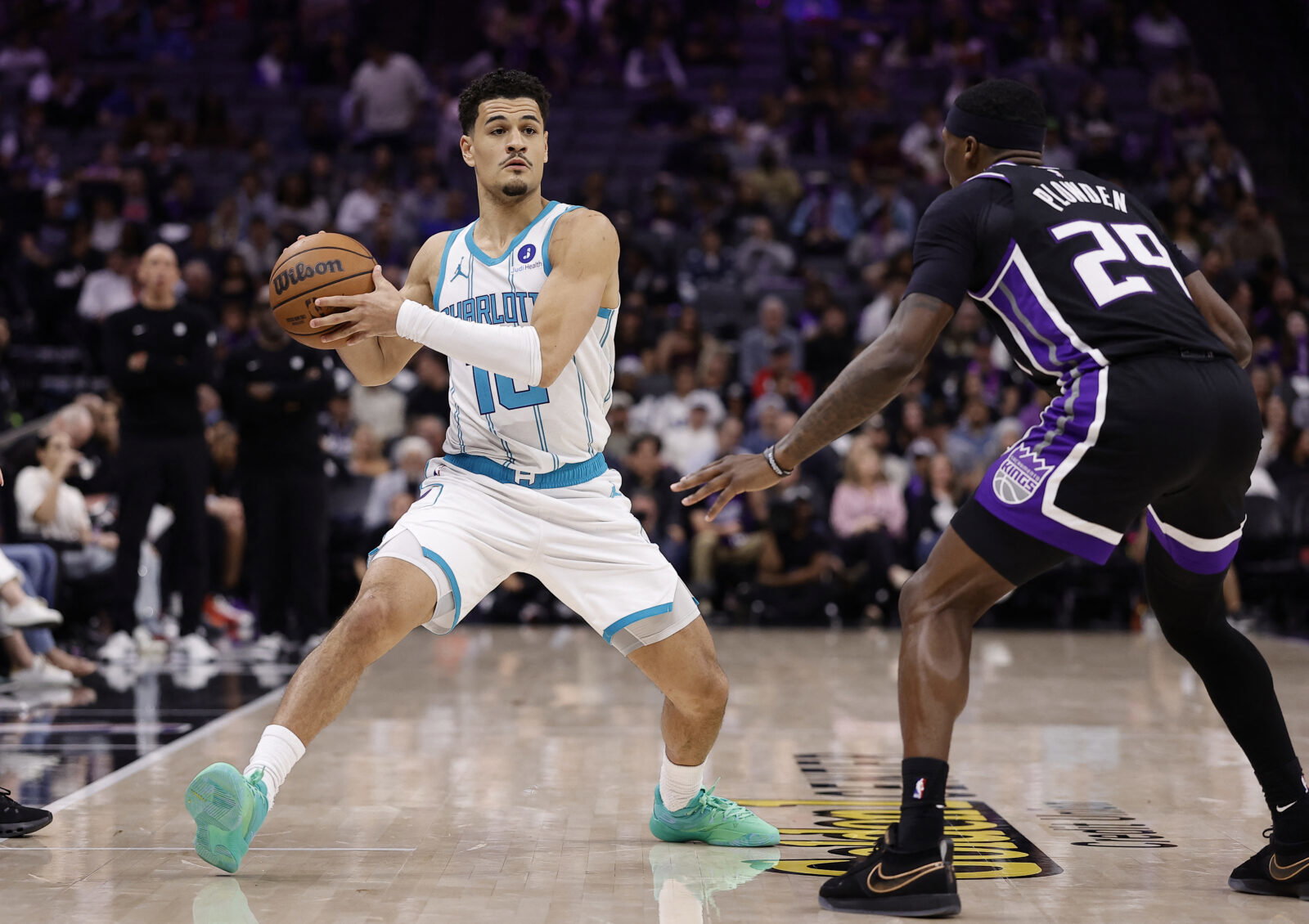 Mar 11, 2026; Sacramento, California, USA; Charlotte Hornets guard Josh Green (10) looks to pass the ball against Sacramento Kings forward/guard Daeqwon Plowden (29) during the third quarter at Golden 1 Center. Mandatory Credit: Kelley L Cox-Imagn Images