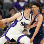 Apr 5, 2026; Sacramento, California, USA; Sacramento Kings center Maxime Raynaud (left) dribbles against LA Clippers guard Kobe Sanders (right) during the fourth quarter at Golden 1 Center. Mandatory Credit: Darren Yamashita-Imagn Images