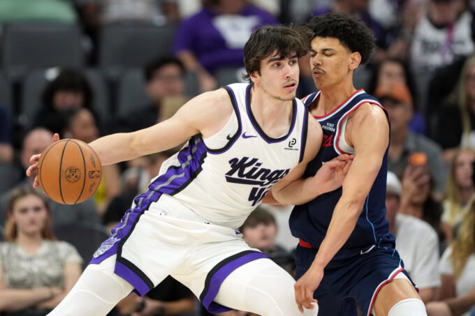 Apr 5, 2026; Sacramento, California, USA; Sacramento Kings center Maxime Raynaud (left) dribbles against LA Clippers guard Kobe Sanders (right) during the fourth quarter at Golden 1 Center. Mandatory Credit: Darren Yamashita-Imagn Images