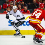 Apr 16, 2026; Calgary, Alberta, CAN; Los Angeles Kings center Scott Laughton (21) skates with the puck against the Calgary Flames during the third period at Scotiabank Saddledome. Mandatory Credit: Sergei Belski-Imagn Images