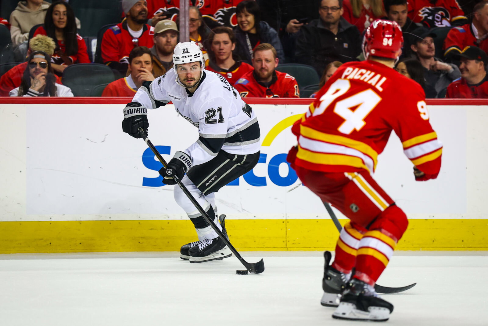 Apr 16, 2026; Calgary, Alberta, CAN; Los Angeles Kings center Scott Laughton (21) skates with the puck against the Calgary Flames during the third period at Scotiabank Saddledome. Mandatory Credit: Sergei Belski-Imagn Images