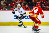 Apr 16, 2026; Calgary, Alberta, CAN; Los Angeles Kings center Scott Laughton (21) skates with the puck against the Calgary Flames during the third period at Scotiabank Saddledome. Mandatory Credit: Sergei Belski-Imagn Images