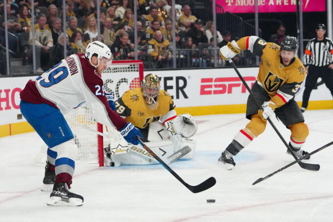 May 24, 2026; Las Vegas, Nevada, USA; Vegas Golden Knights goaltender Carter Hart (79) and defenseman Brayden McNabb (3) defend against Colorado Avalanche center Nathan MacKinnon (29) during the second period in game three of the Western Conference Final of the 2026 Stanley Cup Playoffs at T-Mobile Arena. Mandatory Credit: Stephen R. Sylvanie-Imagn Images