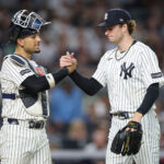 Jun 19, 2026; Bronx, New York, USA; New York Yankees pitcher Cam Schlittler (31) shakes hands with catcher J.C. Escarra (25) after the top of the sixth inning against the Cincinnati Reds at Yankee Stadium. Mandatory Credit: Vincent Carchietta-Imagn Images