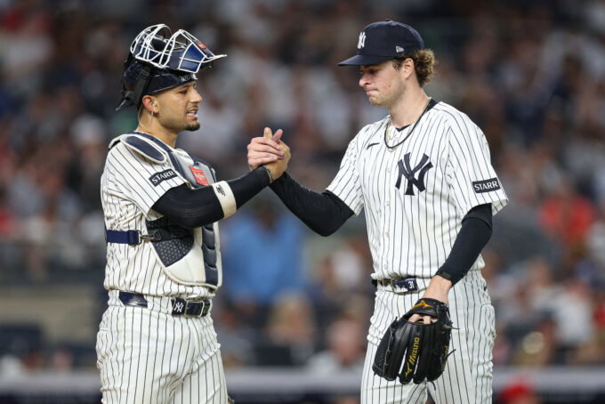 Jun 19, 2026; Bronx, New York, USA; New York Yankees pitcher Cam Schlittler (31) shakes hands with catcher J.C. Escarra (25) after the top of the sixth inning against the Cincinnati Reds at Yankee Stadium. Mandatory Credit: Vincent Carchietta-Imagn Images