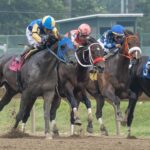 Horses in the first race of day round the third turn. 2026 Haskell Day at Monmouth Park in Oceanport, NJ on July 18, 2026.