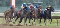 Horses in the first race of day round the third turn. 2026 Haskell Day at Monmouth Park in Oceanport, NJ on July 18, 2026.