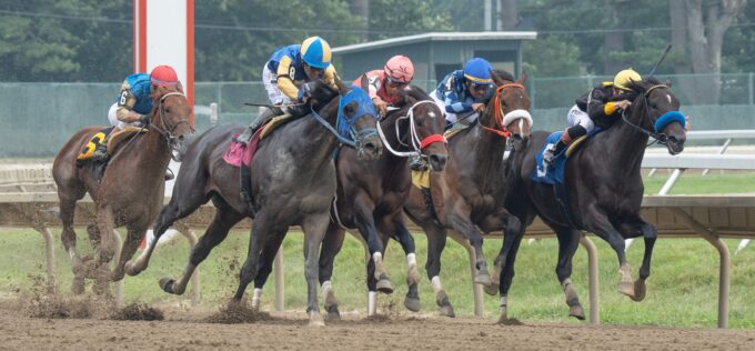 Horses in the first race of day round the third turn. 2026 Haskell Day at Monmouth Park in Oceanport, NJ on July 18, 2026.