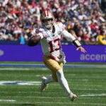 Sep 11, 2026; Melbourne, Victoria, Australia; San Francisco 49ers quarterback Brock Purdy (13) runs with the ball in the second half against the Los Angeles Rams during the 2026 NFL Melbourne Game at Melbourne Cricket Ground. Mandatory Credit: Kirby Lee-Imagn Images