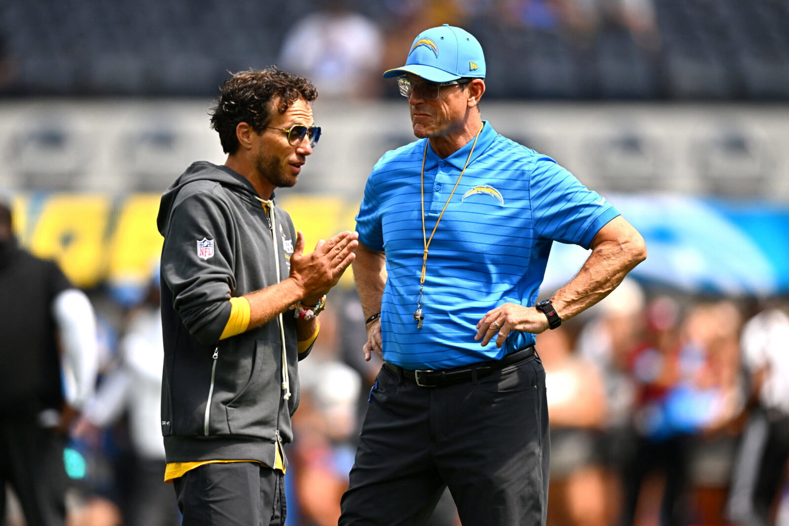 Sep 13, 2026; Inglewood, California, USA; Los Angeles Chargers head coach Jim Harbaugh stands on the field with offensive coordinator Mike McDaniel prior to a game against the Arizona Cardinals at SoFi Stadium.at SoFi Stadium. Mandatory Credit: William Liang-Imagn Images