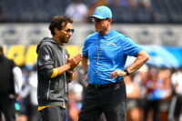 Sep 13, 2026; Inglewood, California, USA; Los Angeles Chargers head coach Jim Harbaugh stands on the field with offensive coordinator Mike McDaniel prior to a game against the Arizona Cardinals at SoFi Stadium.at SoFi Stadium. Mandatory Credit: William Liang-Imagn Images