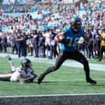 Sep 13, 2026; Charlotte, North Carolina, USA; Carolina Panthers wide receiver Jalen Coker (18) runs the ball for a touchdown in the fourth quarter against the Chicago Bears at Bank of America Stadium. Mandatory Credit: Jim Dedmon-Imagn Images